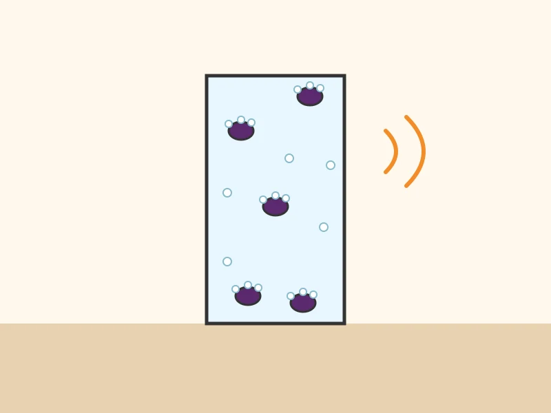 A tall glass of sparkling water where raisins covered in bubbles move up and down.